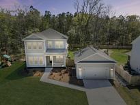 Beautiful two-story home featuring lush front yard and a detached garage at 4209 Royal Harbor Rd, Hollywood, SC 29449