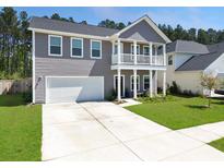 Charming two-story home with a spacious driveway and manicured lawn at 4310 Cotton Flat Rd, Summerville, SC 29485