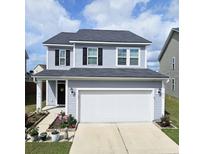 Charming two-story home featuring a well-maintained front yard, a two-car garage, and blue vinyl siding at 470 Spectrum Rd, Summerville, SC 29486
