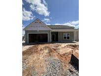 Single-story home featuring a two-car garage and a charming covered front porch at 625 Marsh Cove Cir, Summerville, SC 29486