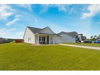 Charming single-story home with well-manicured lawn and attached two-car garage, perfect for Gathering living at 706 Squire Pope Rd, Summerville, SC 29486