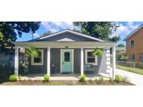 Charming home showcasing a quaint front porch with decorative plants and a cozy seating area at 928 Sycamore Ave, Charleston, SC 29407