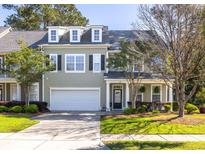 Charming townhome with a well-manicured lawn and attached garage, featuring classic architectural details at 120 Fresh Meadow Ln, Mount Pleasant, SC 29466