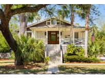 Charming two-story home with a welcoming front porch, mature landscaping, and a well-maintained yard at 1316 Thompson, Sullivans Island, SC 29482