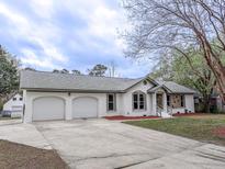 Charming brick home featuring a well-maintained lawn and a two-car attached garage at 132 Tranquil Ln, Ladson, SC 29456