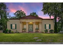 Stately home featuring a columned portico entrance, shutters, and lush lawn at 2 Leone Ln, Hanahan, SC 29410