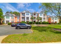 Inviting condo complex with lush landscaping and ample parking for residents and visitors at 2221 Chatelain Way, Mount Pleasant, SC 29464