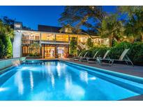 Inviting backyard pool with waterfall feature and lounge chairs, perfect for relaxation and outdoor entertaining at 2629 Goldbug Ave, Sullivans Island, SC 29482