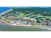 Stunning aerial view of the Atrium Villa complex, surrounded by lush golf courses and ocean views at 2933 Atrium Villa Dr # 33, Seabrook Island, SC 29455