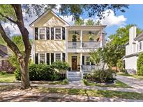 Charming two-story home with a welcoming front porch and beautiful landscaping at 3023 Macbeth Creek Dr, Charleston, SC 29414