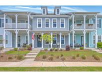 Charming townhomes boast double porches, inviting curb appeal, and classic architectural details at 3119 Sturbridge Rd, Mount Pleasant, SC 29466