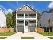 Charming two-story home features a double porch and a well-manicured lawn for a great curb appeal at 3718 Sandy Gate Ln, Mount Pleasant, SC 29466