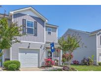 Charming townhome with a garage, manicured landscaping, and a welcoming entryway, complete with South Carolina flag at 531 Truman Dr, Goose Creek, SC 29445