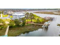 Expansive home overlooking waterfront, featuring private dock and serene coastal charm at 545 Towles Crossing Dr # 29455, Johns Island, SC 29455