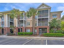 Inviting condo exterior with screened porches, brick accents, and palm trees at 1022 Basildon Rd, Mount Pleasant, SC 29466