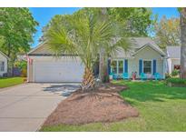 Charming single-story home with a well-manicured lawn, blue shutters, and inviting front porch seating at 1315 Old Mill Ln, Mount Pleasant, SC 29464