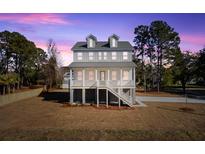 Charming two-story home with landscaped yard and classic coastal architecture at twilight at 1577 Periwinkle Dr, Mount Pleasant, SC 29466