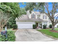 Charming two-story home with a well-maintained lawn, a two car garage, and lush landscaping in a quiet neighborhood at 2136 Baldwin Park Dr, Mount Pleasant, SC 29466