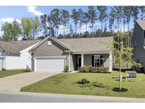 Charming single-story home with a two-car garage, manicured lawn, and beautiful landscaping at 222 Hayworth Rd, Summerville, SC 29486