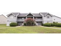Gray two-story condo building with well-maintained lawn and mature landscaping at 2402 Riverridge Ct, Moncks Corner, SC 29461