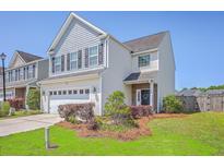 Charming two-story home with a well-manicured lawn and an attached two-car garage at 255 Longford Dr, Summerville, SC 29483