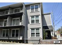 Exterior view of a multi-story home with a private balcony and an inviting entrance at 259 E. Bay St # 1A, Charleston, SC 29401