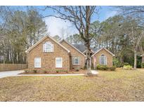 Charming single Gathering home with classic brick exterior, mature trees and meticulous landscaping at 298 Hook Ln, Mount Pleasant, SC 29464