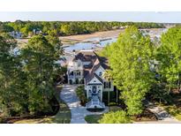 Stunning waterfront home featuring a manicured lawn and a private dock, perfect for enjoying waterfront living at 3600 Henrietta Hartford Rd, Mount Pleasant, SC 29466