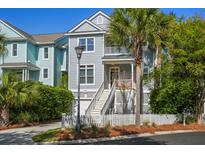 Charming two-story home with a spacious front porch, beautiful landscaping, and inviting curb appeal at 40 Grand Pavilion Blvd, Isle of Palms, SC 29451
