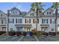 Charming townhomes with colorful doors, manicured landscaping and palm trees, offering a welcoming curb appeal at 4926 Lake Palmetto Ln, North Charleston, SC 29418