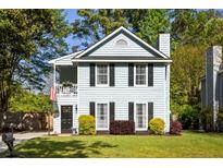 Charming two-story home with a light blue exterior, black shutters, and a cozy front porch at 540 Castle Hall Rd, Mount Pleasant, SC 29464