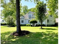 Inviting home with manicured lawn and lush landscaping, offering great curb appeal and a welcoming atmosphere at 5691 Captain Kidd Rd, Hollywood, SC 29449
