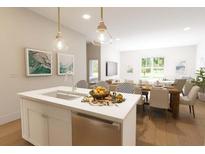 Bright kitchen with an island sink, stainless steel appliances, and pendant lighting at 7621 Indigo Palms Way, Johns Island, SC 29455