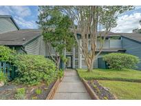 Charming two-story home with a serene walkway leading to the front door, surrounded by lush landscaping at 1134 Shadow Lake Cir # 55, Mount Pleasant, SC 29464