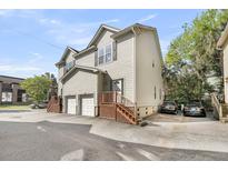 Two-story home with driveway parking, two garage spaces, and wooden staircase at 118 Congress St # F, Charleston, SC 29403