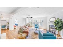 Bright living room boasts natural light, wood floors, fireplace, and stylish furnishings at 118 Regent St, Summerville, SC 29483