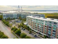 Stunning aerial view of the apartments showcasing its waterfront view and the Ravenel Bridge in the background at 155 Wingo Way # 433, Mount Pleasant, SC 29464