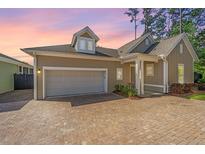 Charming home with a brick driveway and well-manicured landscaping offers great curb appeal at 1623 Adventure Xing # 109, Mount Pleasant, SC 29466