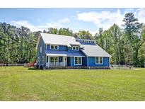 Charming two-story blue home with metal roof and inviting front porch at 2102 Williams Rd, Ruffin, SC 29475