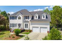 Beautiful two-story home featuring a two-car garage, manicured lawn and mature trees at 2290 Deer Sight Way, Mount Pleasant, SC 29466
