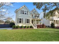 Charming two-story home with a well-manicured lawn, lush landscaping, and welcoming front porch at 2292 Skyler Dr, Mount Pleasant, SC 29466