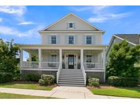 Charming two-story home featuring a welcoming front porch, classic design, and well-maintained landscaping at 2405 Louisville St, Charleston, SC 29492