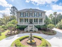 Beautiful two-story home with front porch and circular driveway with fountain at 2444 Darts Cove Way, Mount Pleasant, SC 29466
