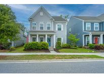 Charming two-story home with gray siding, white trim, landscaped yard, and welcoming blue front door at 249 Oak View Way, Summerville, SC 29483