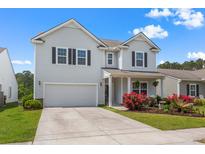 Charming two-story home with attached garage, manicured lawn, and colorful landscaping at 2840 Conservancy Ln, Charleston, SC 29414