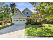 Charming two-story home with well-manicured lawn, attached garage, and inviting front porch at 3001 Grand Bay Ln, Johns Island, SC 29455