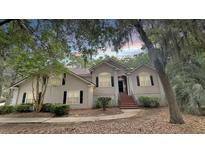 Charming two-story home featuring neutral siding, black shutters, and a brick stairway entrance at 3023 Maritime Forest Dr, Johns Island, SC 29455
