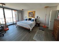 Spacious bedroom featuring floor-to-ceiling windows, hardwood floors and natural light at 330 Concord St # 14D, Charleston, SC 29401