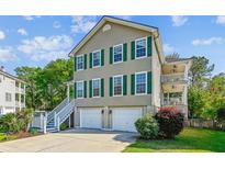 Charming home with two-car garage, landscaped yard, and double porches perfect for outdoor enjoyment at 339 Clayton Dr, Charleston, SC 29414