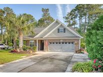 Charming home featuring a well-manicured lawn, two-car garage, and inviting curb appeal at 347 Prestwick Ct, Summerville, SC 29483